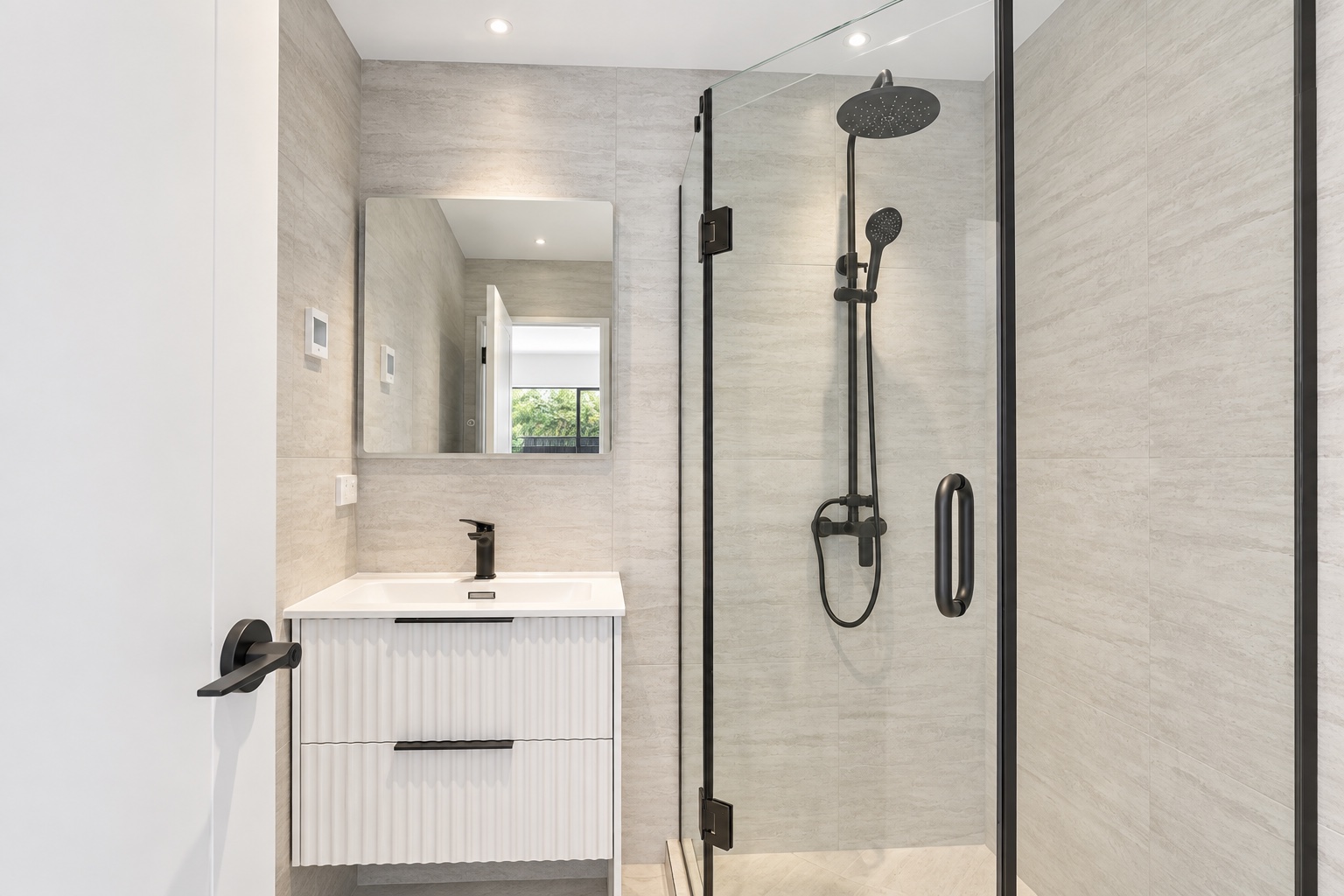 Modern tiled shower with matte-black fixtures