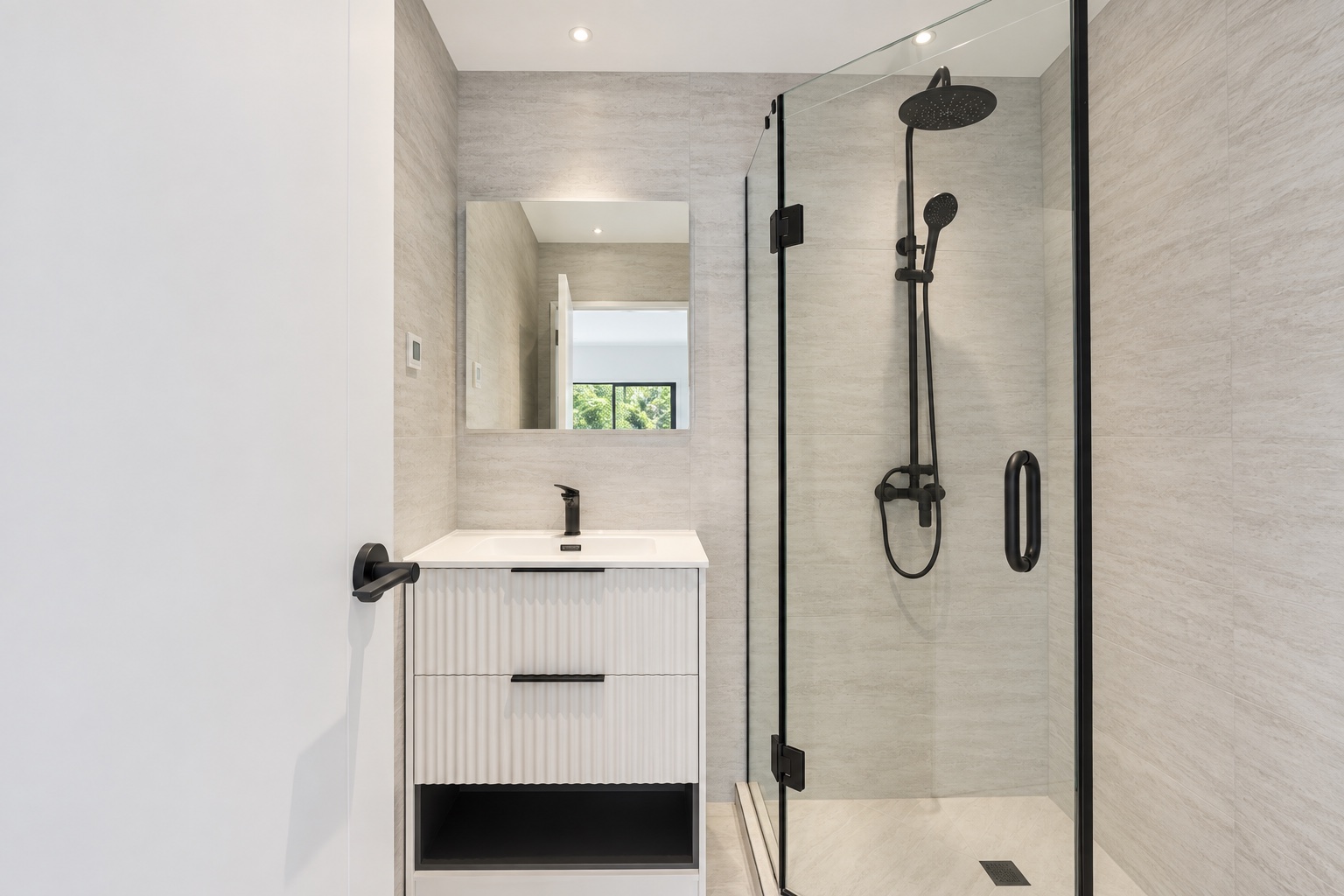 Tiled bathroom with matte-black fixtures